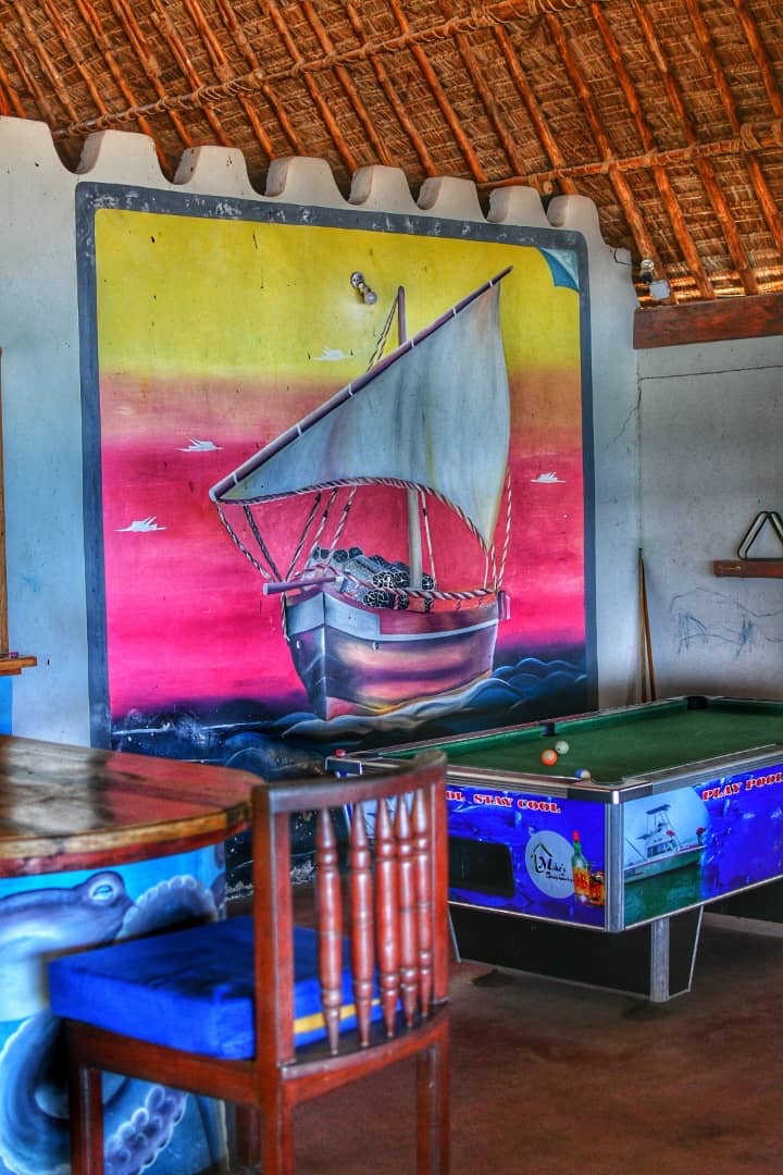 Pool table beneath a painted dhow mural inside the bar