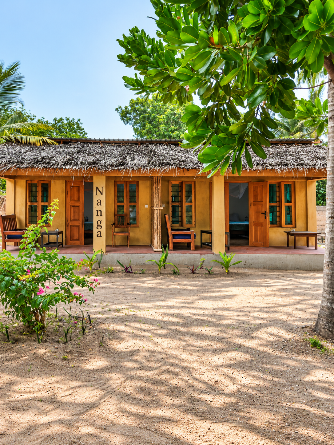 Nanga bungalow with makuti roof and ochre veranda facing the sand